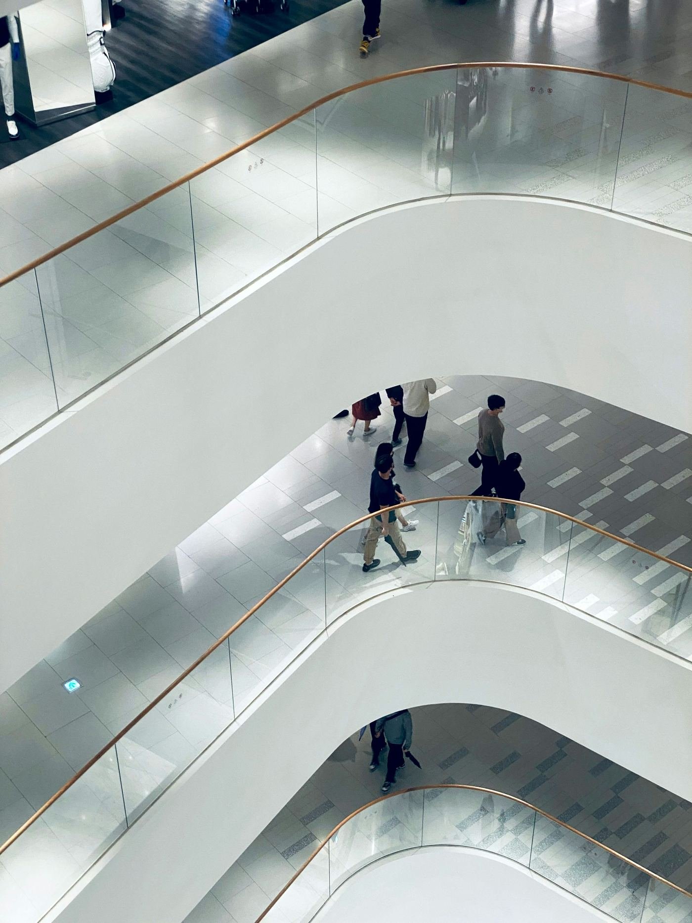People moving between floors of an open-plan office building